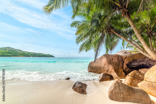 Rocks and palm trees by the sea in world famous Anse Lazio