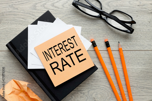 interest rates text on orange sticker on notepad photo