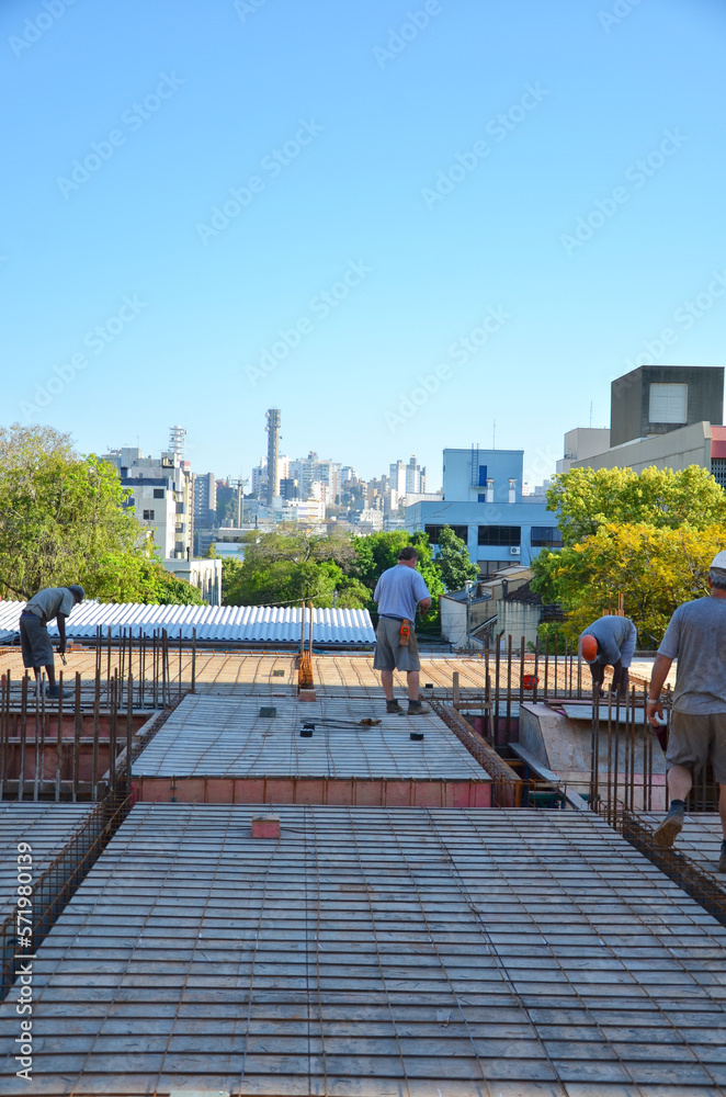 Construction work in Brazil - building in reinforced concrete  - In the background, view of the Bela Vista neighborhood in Porto Alegre