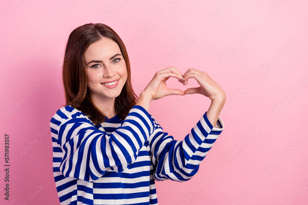 Photo of lovely charming cheerful lady two arm make heart sign demonstrate love feelings empty space isolated on pink color background Photo of lovely charming cheerful lady two arm make heart sign demonstrate love feelings empty space isolated on pink color background