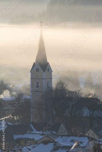 Church in windischgarsten with sun lights and fog photo