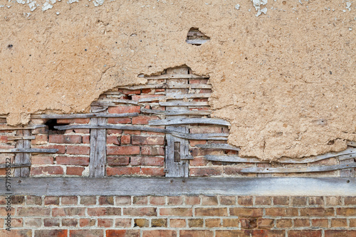 Half-timbered brick wall covered with daub