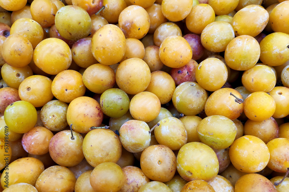 Stack of Mirabelle plums on a market stall