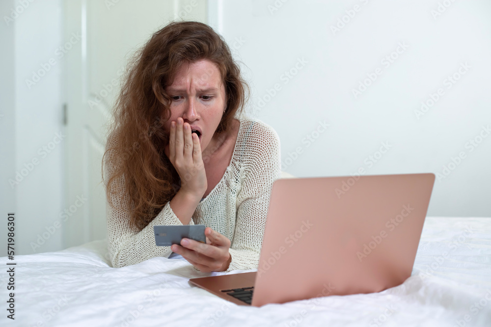 Internet fraud. Nervous sad upset unhappy confused young woman, stressed worried lady having problem with paying, buying online, shopping, stolen money, payments with credit blocked bank card Internet fraud. Nervous sad upset unhappy confused young woman, stressed worried lady having problem with paying, buying online, shopping, stolen money, payments with credit blocked bank card