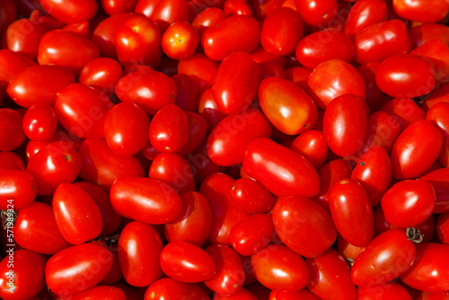 Stack of red plum tomatoes a market stall © BreizhAtao