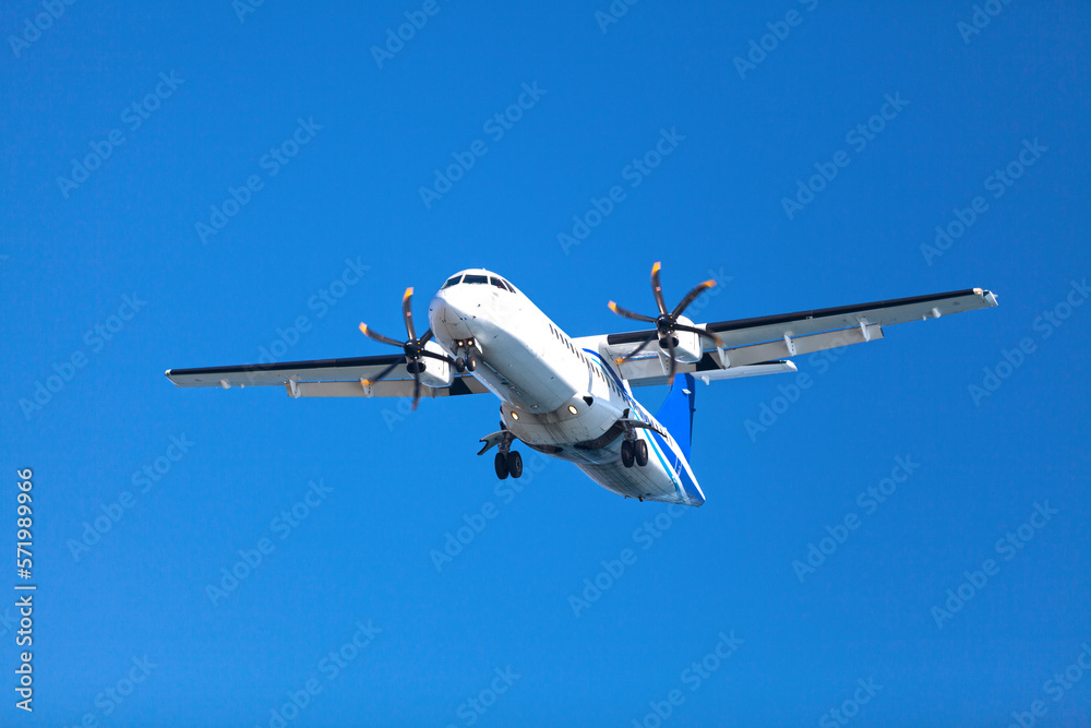 Propeller airplane landing to the airport