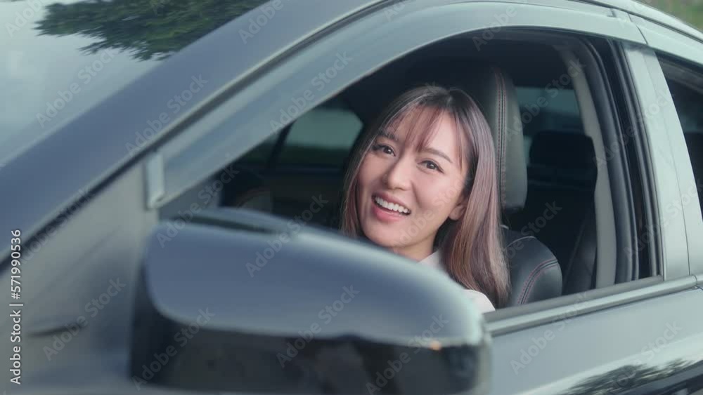 Young asian beautiful woman driving a car with fastened seatbelt Young asian beautiful woman driving a car with fastened seatbelt