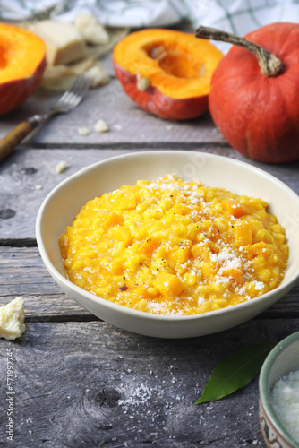 Italian food. Plate of pumpkin risotto and grated parmesan cheese