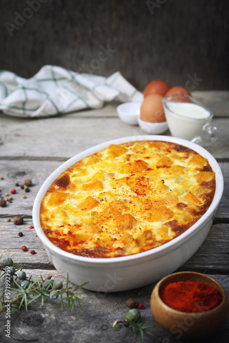 French cuisine. Vegetable pumpkin clafoutis in ceramic bakeware, eggs and cream