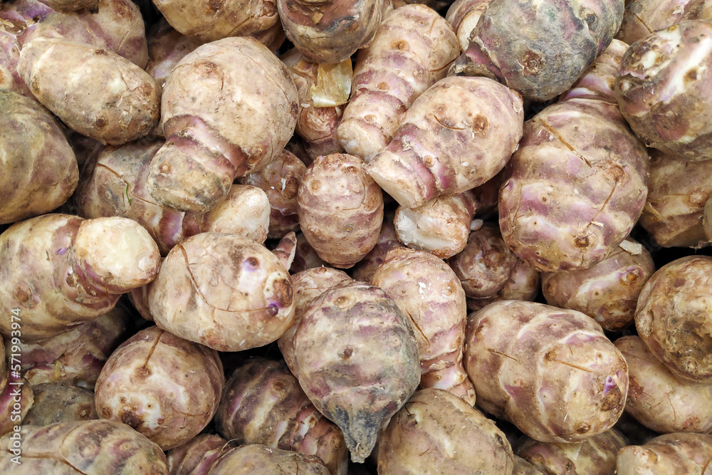 Stack of Jerusalem artichokes on a market stall Stack of Jerusalem artichokes on a market stall