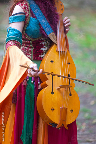 Medieval female minstrel playing vielle