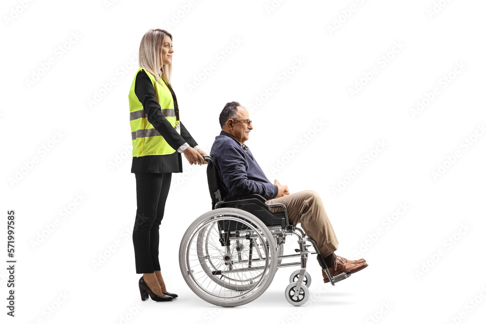 Female special assitance worker standing with a marture man in a wheelchair Female special assitance worker standing with a marture man in a wheelchair