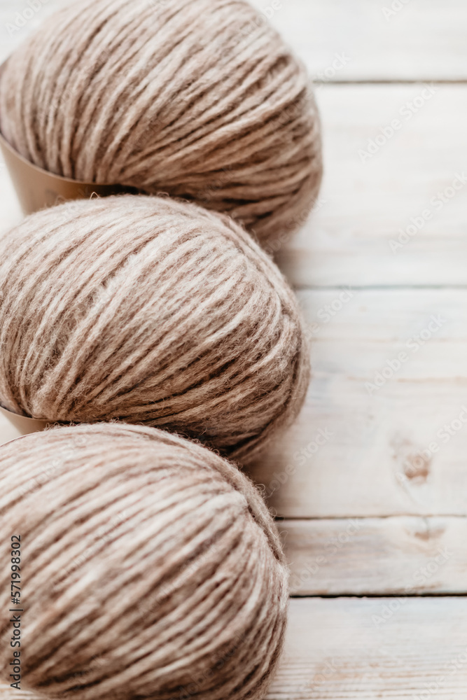 Three coils of light, skittish wool threads for close-up knitting Three coils of light, skittish wool threads for close-up knitting