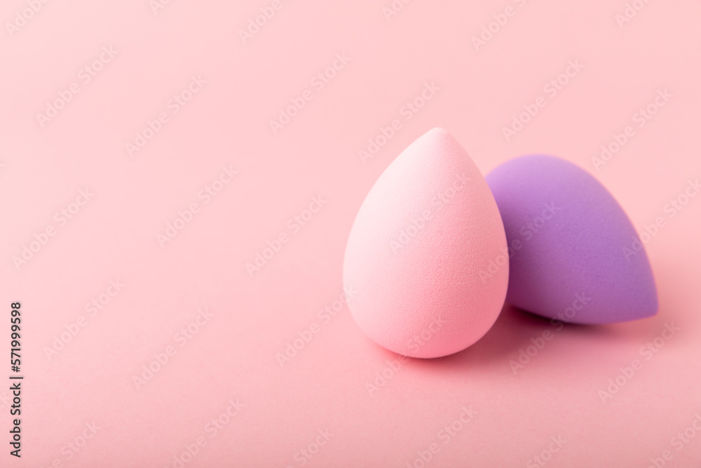 Beauty blender on a pink background.Bright sponges for make-up cosmetics. Makeup products. Beauty concept. Place for text. Space for copy. Flat lay