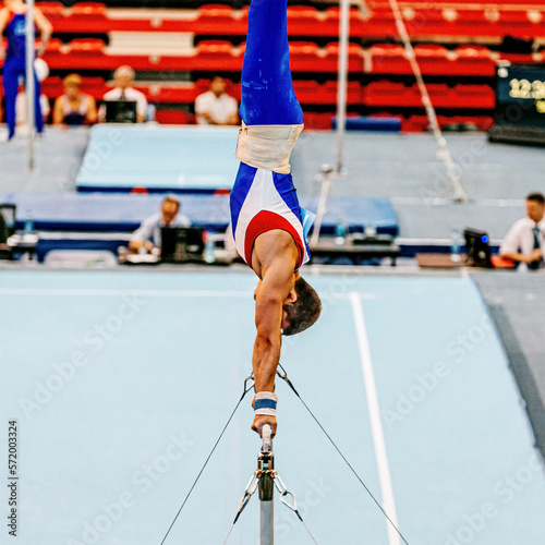 men gymnast perform exercise on horizontal bar © sports photos