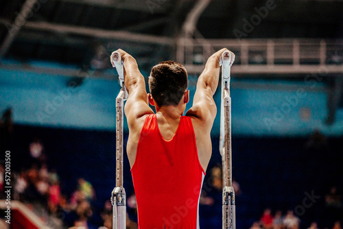 athlete gymnast exercise on parallel bars gymnastics