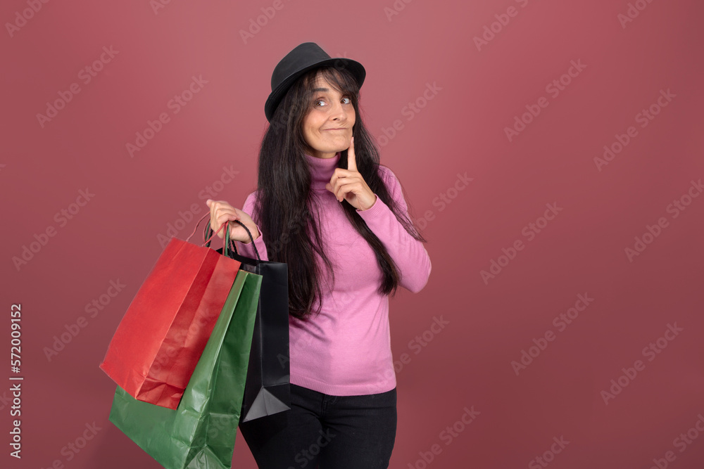 long-haired woman with hat and paper bags isolated from the background long-haired woman with hat and paper bags isolated from the background