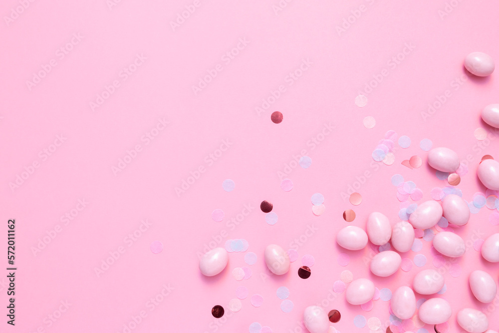 Bunch of candy eggs on pink background. Minimal Easter concept with copy space for text. Festive day backdrop. Flat lay style with minimalistic design. Bunch of candy eggs on pink background. Minimal Easter concept with copy space for text. Festive day backdrop. Flat lay style with minimalistic design.