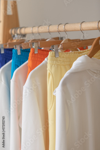 Clothes hang on a shelf in a designer clothes store. hangers with fashionable clothes