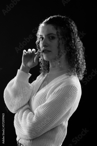 dramatic portrait of a young woman with curly hair