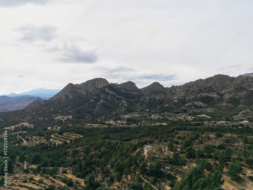 Limestone rock ridge Els Castellets, Sella.Looking North West from Puig Campana to Penya Sella and Sierra de Aitana, Finestrat, Alicante province,Spain