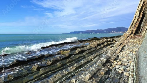 Wallpaper Mural Sea waves on the Black Sea coast. Waves splash on the beach with pebbles in the rays of the sun. Sunset on the Black Sea. Panoramic view of the Black Sea. Kiseleva Rock, Russia, Agoi Torontodigital.ca