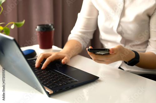 Business woman working at the desk and using a smartphone.Woman texting text message  social media business.