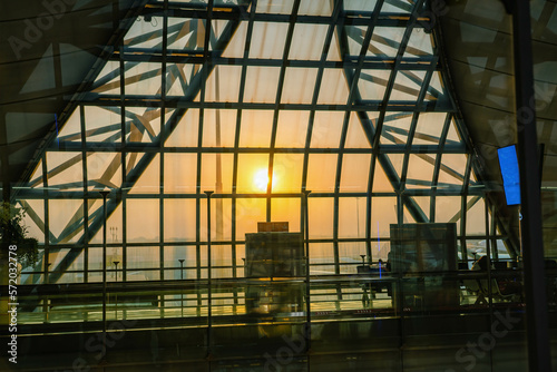 Scenic Sunrise over Suvarnabhumi Airport seen from inside through the window framework