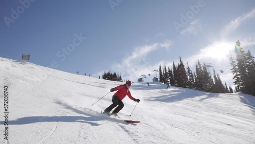 Fast downhill skiers with sunstar, ski mountain, sunny day, winter, ski hill, Whistler BC. HD 24fps