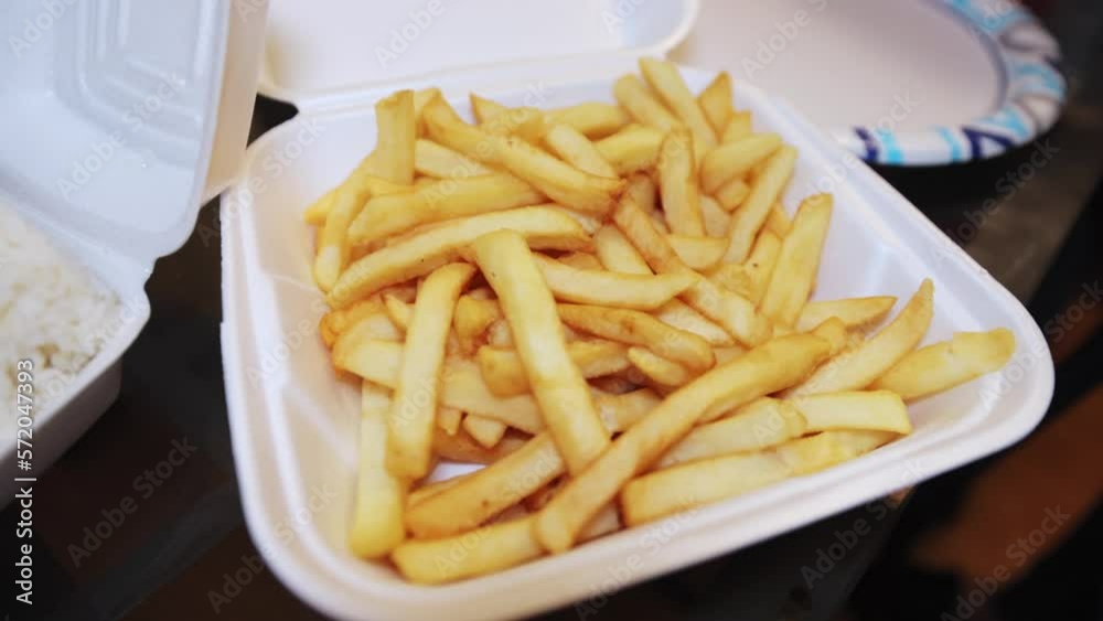 close up of large french fries on a disposable plate close up of large french fries on a disposable plate