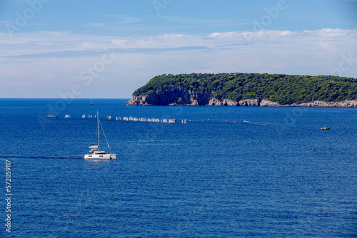 sailboats compete in a sailing regatta, sailboat race, the island is in the background, sunny day, clear weather, intense blue. Adriatic Sea, Dubrovnik, Croatia