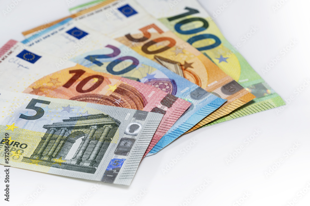 Some banknotes in euro currency on a light gray background, finance concept, copy space, selected focus, narrow depth of field Some banknotes in euro currency on a light gray background, finance concept, copy space, selected focus, narrow depth of field