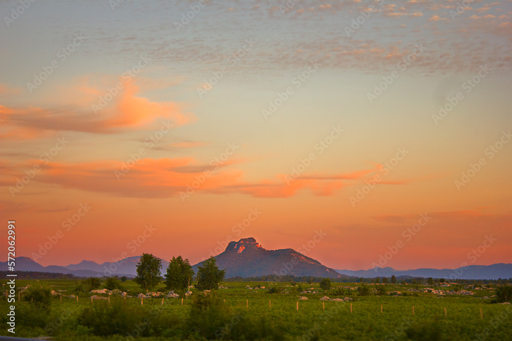 picturesque sunset over the steppe with mountains on the horizon