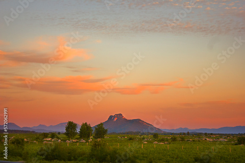 picturesque sunset over the steppe with mountains on the horizon © tillottama