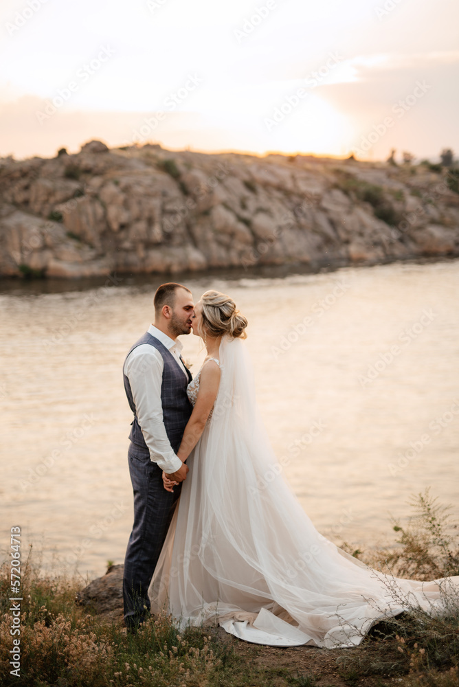 bride blonde girl and groom near the river bride blonde girl and groom near the river