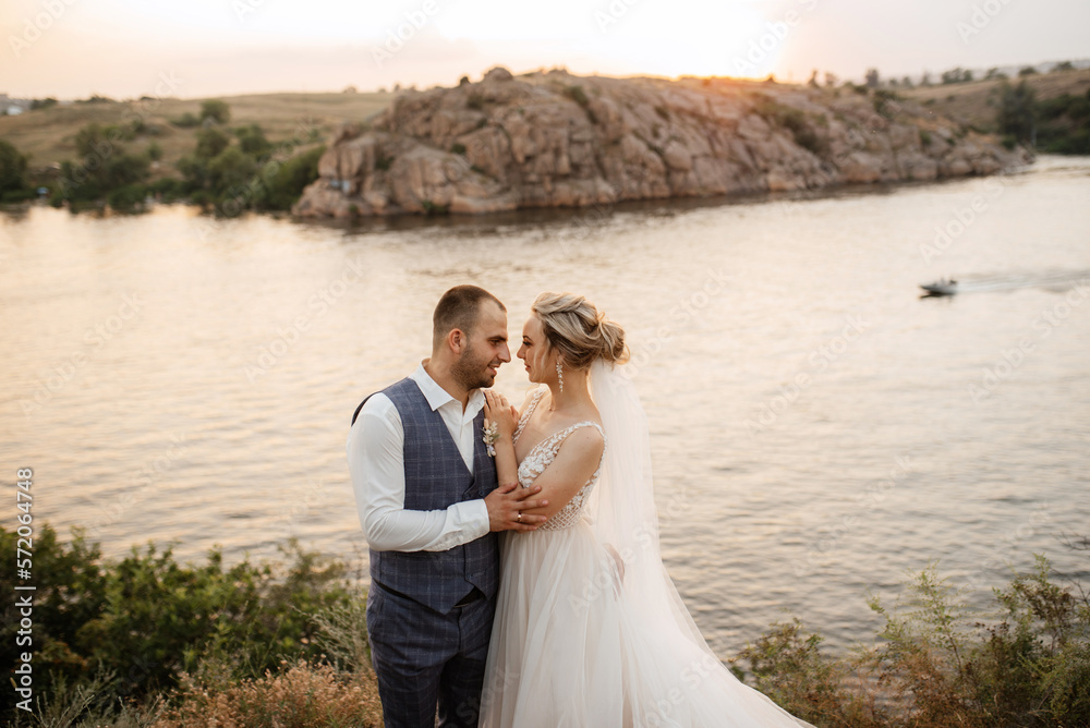 bride blonde girl and groom near the river bride blonde girl and groom near the river