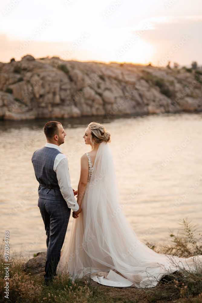 bride blonde girl and groom near the river