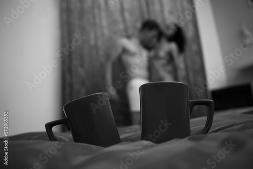 person watching tv. Sexy coffee cups. Sensual. Shadow. Man and woman. Romantic. 