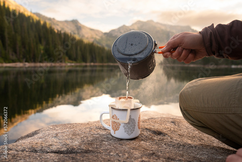 Fototapeta Naklejka Na Ścianę i Meble -  Hiker drinking coffee at alpine lake in Montana on a backpacking trip