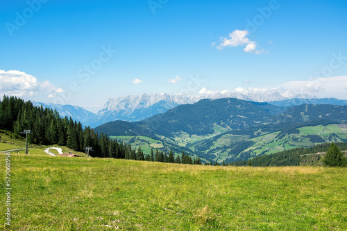 Panorama of Austrian Alps with forest and green meadow. Grafenberg Hill  Wagrain.