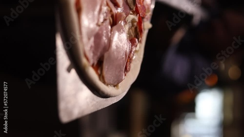 Italian chef making margaritta pizza with tomato sause and mozzarella, traditional food in italy, high kitchen gastrobar restaurant, street food delivery. photo