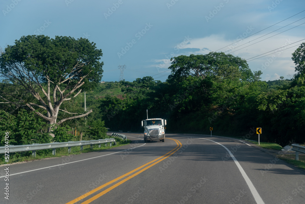 White truck on a highway in tropical climate. Colombia