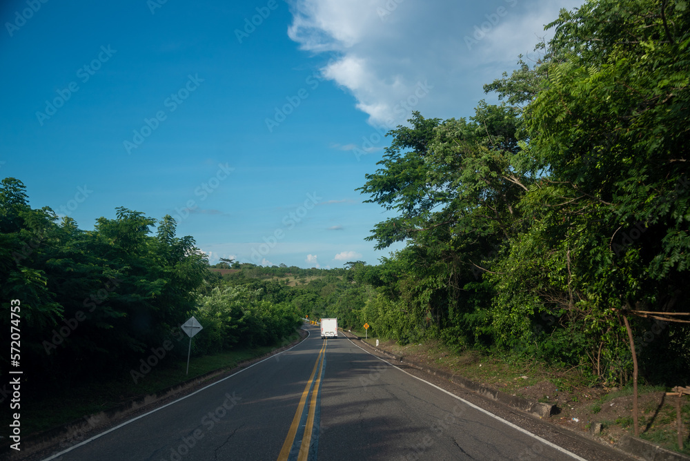 White truck on a rural highway in Colombia. White truck on a rural highway in Colombia.