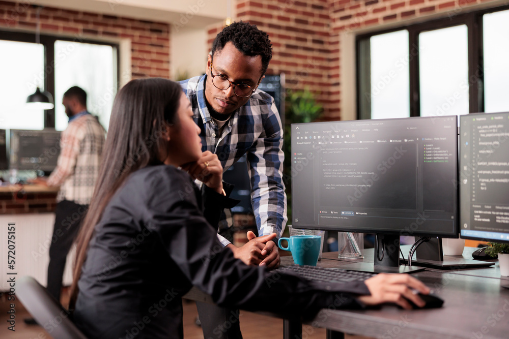 Team of database admins debugging algorithm working in software developing office. Two cloud programers analyzing source code on computer monitor, comparing data script in busy agency office. Team of database admins debugging algorithm working in software developing office. Two cloud programers analyzing source code on computer monitor, comparing data script in busy agency office.
