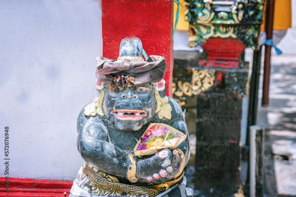 Fototapeta premium Traditional Balinesian guard statue usually placed at entry points to private or public places, close up photo