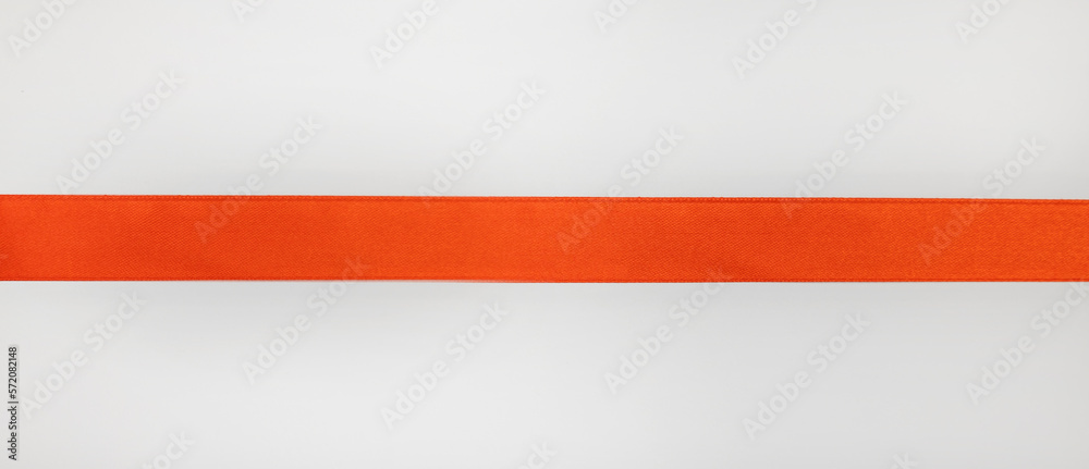 Straight red ribbon on white background, design element for gift decoration.