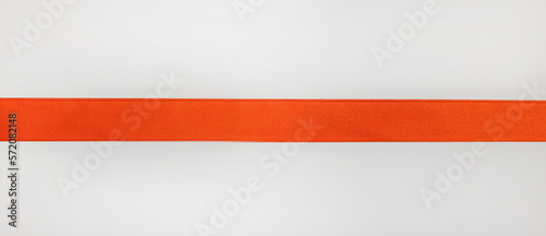 Straight red ribbon on white background, design element for gift decoration.
