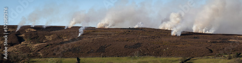 Valokuva Panorama of controlled burning on heather moorland, in the North York Moors