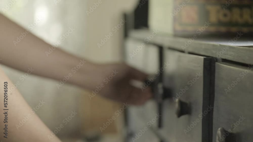 Search, loss, missing item concept. Hands pulling out chest of drawers in a blurry room.slow motion.Cleaning the closets. Woman looking in closet drawers.4k footage Search, loss, missing item concept. Hands pulling out chest of drawers in a blurry room.slow motion.Cleaning the closets. Woman looking in closet drawers.4k footage