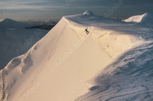 Freeride in morning mountains  winter freeride extreme sport. man snowboarding downhill